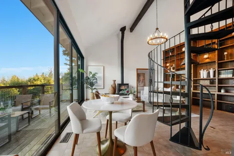 a living room with furniture a rug and a large window