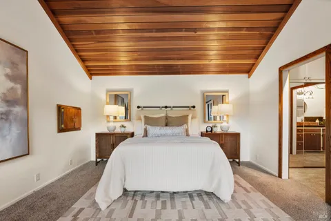 a spacious bedroom with a large bed and a large window