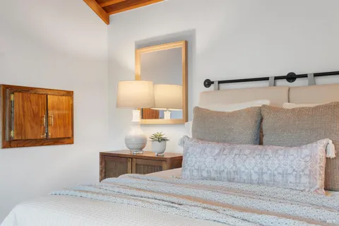 a view of a hallway with wooden floor and a living room