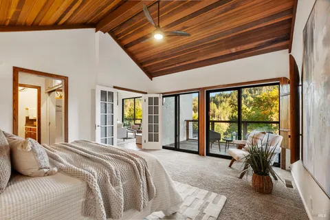 an outdoor living room with furniture and a mirror