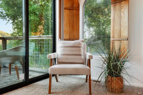 a balcony view with a table and chairs