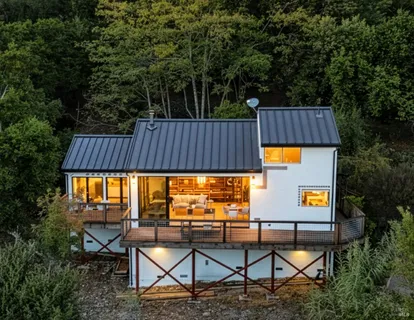 an aerial view of a house with a yard