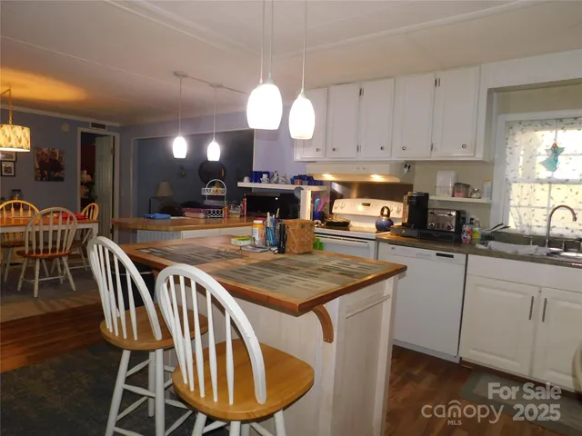 a dining room with wooden floor and a chandelier