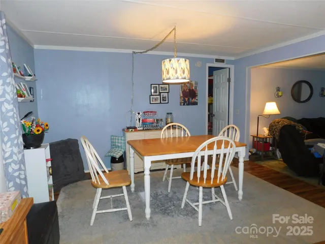a living room with furniture a window and a flat screen tv