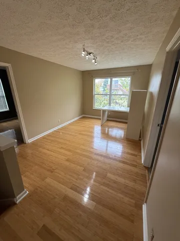 an empty room with a ceiling fan and a window