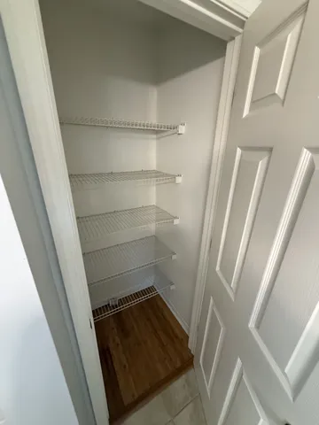 a view of walk in closet with empty racks