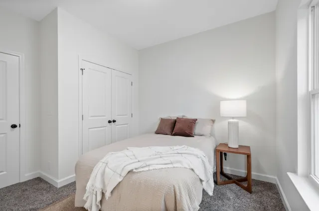 a bedroom with a bed and a lamp