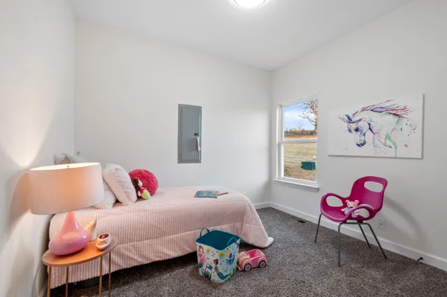 a bedroom with a bed and a chandelier