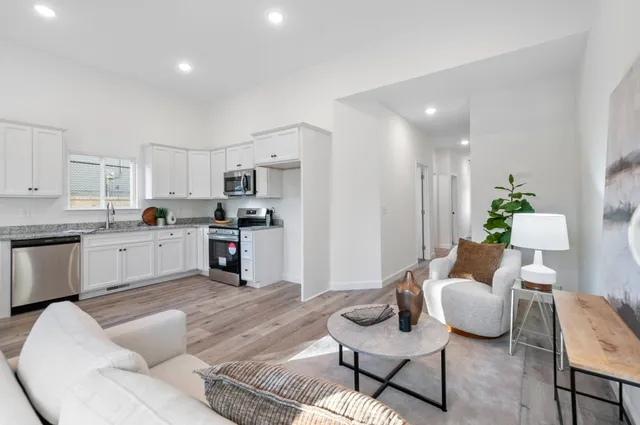 a living room with furniture and kitchen view