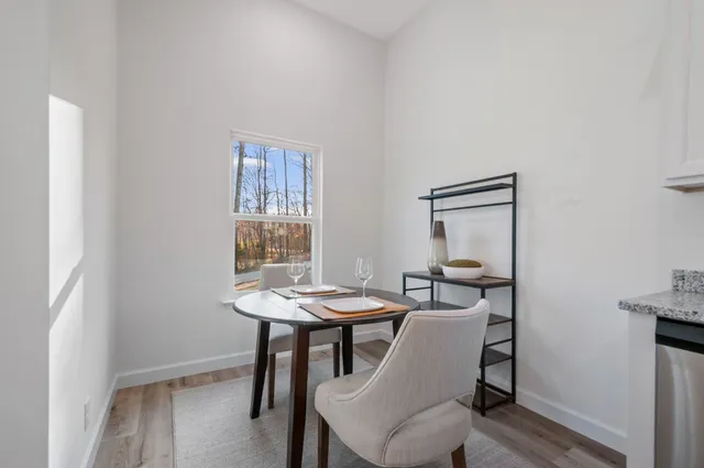 a view of a dining room with furniture and window