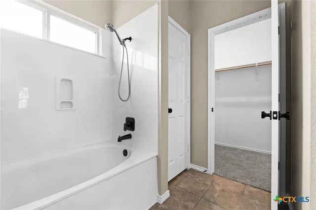 a bathroom with a bathtub and shower