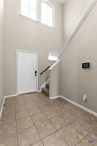 a view of an empty room with stairs