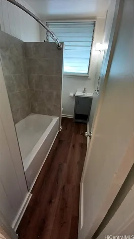 a bathroom with a tub and a shower