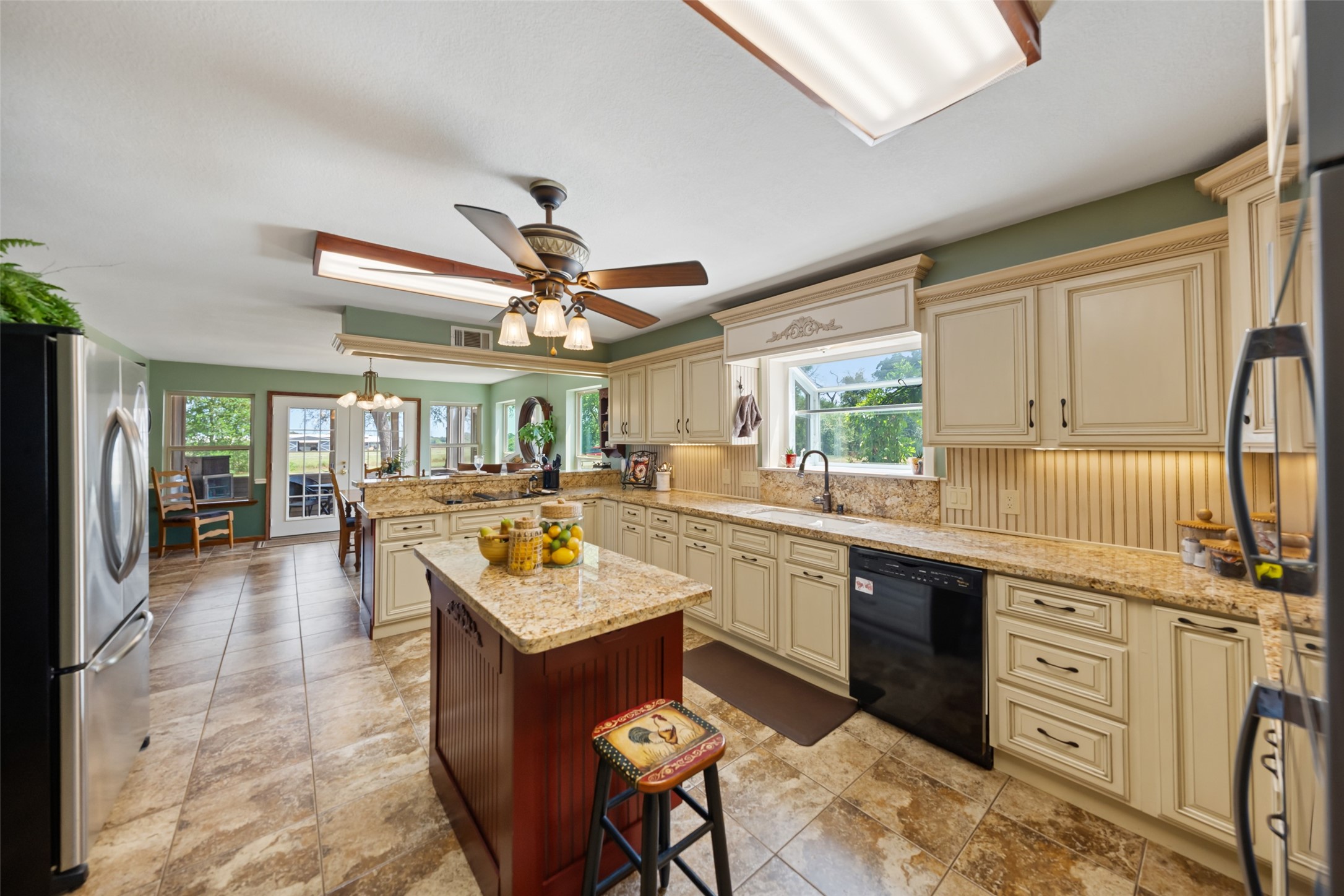 25948 Nelson Road Hempstead, TX 77445 - Photo 9 of 46 Kitchen featuring granite countertops, center island with breakfast bar, abundant cabinetry, double ovens, and stainless steel appliances.