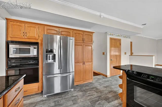 a kitchen with stainless steel appliances granite countertop a refrigerator stove and sink