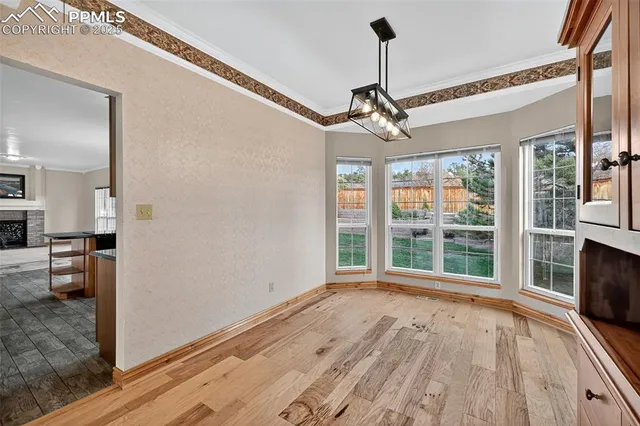 a view of a livingroom with wooden floor and a ceiling fan