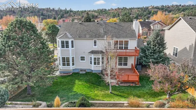 an aerial view of a house with a yard table and chairs