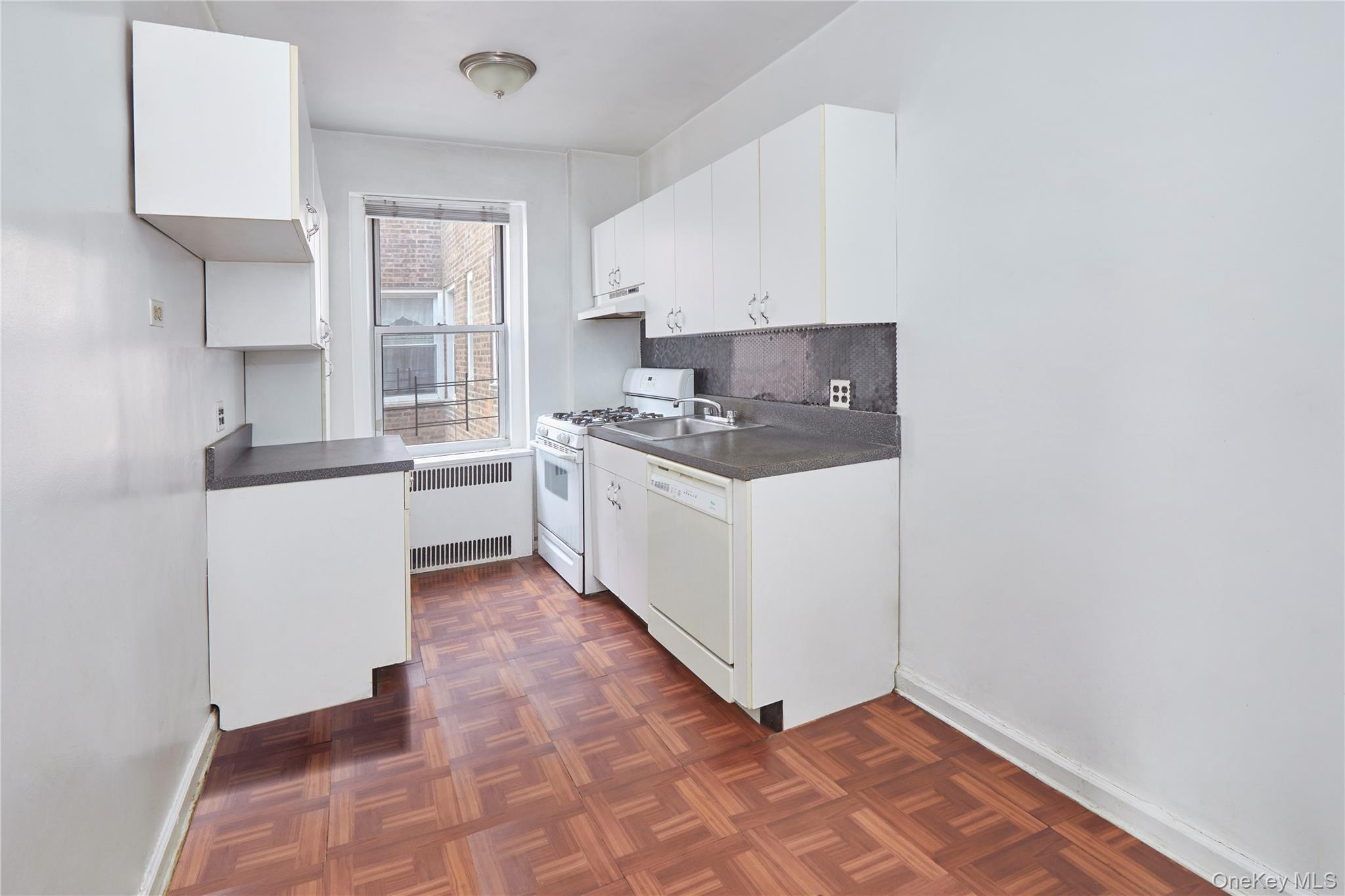 75-40 Austin Street, Unit 5 Queens, NY 11375 - Photo 8 of 12 a kitchen with stainless steel appliances a sink and a stove