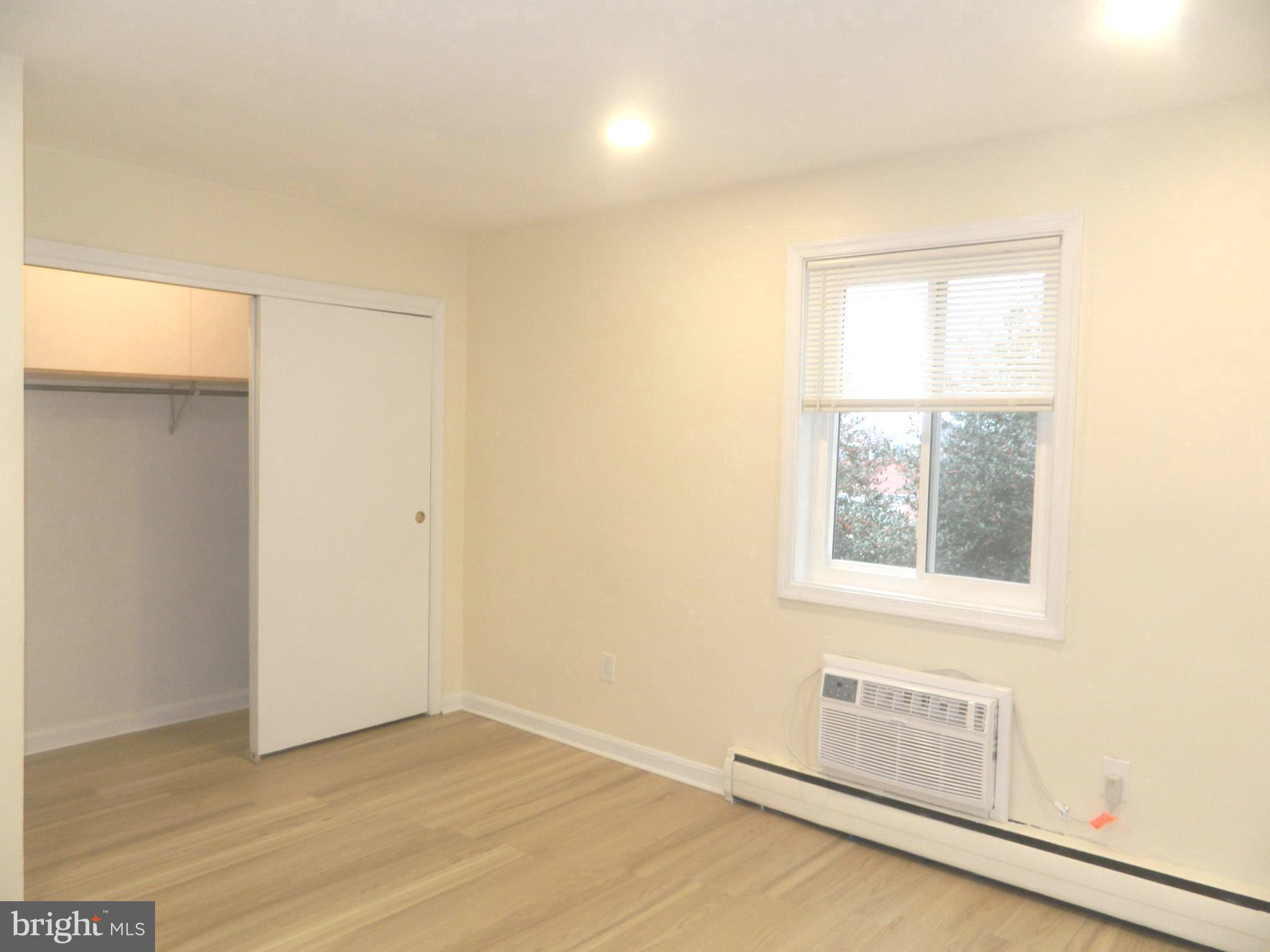 513 12th Street Northeast, Unit 9 Washington, DC 20002 - Photo 17 of 29 an empty room with wooden floor and windows