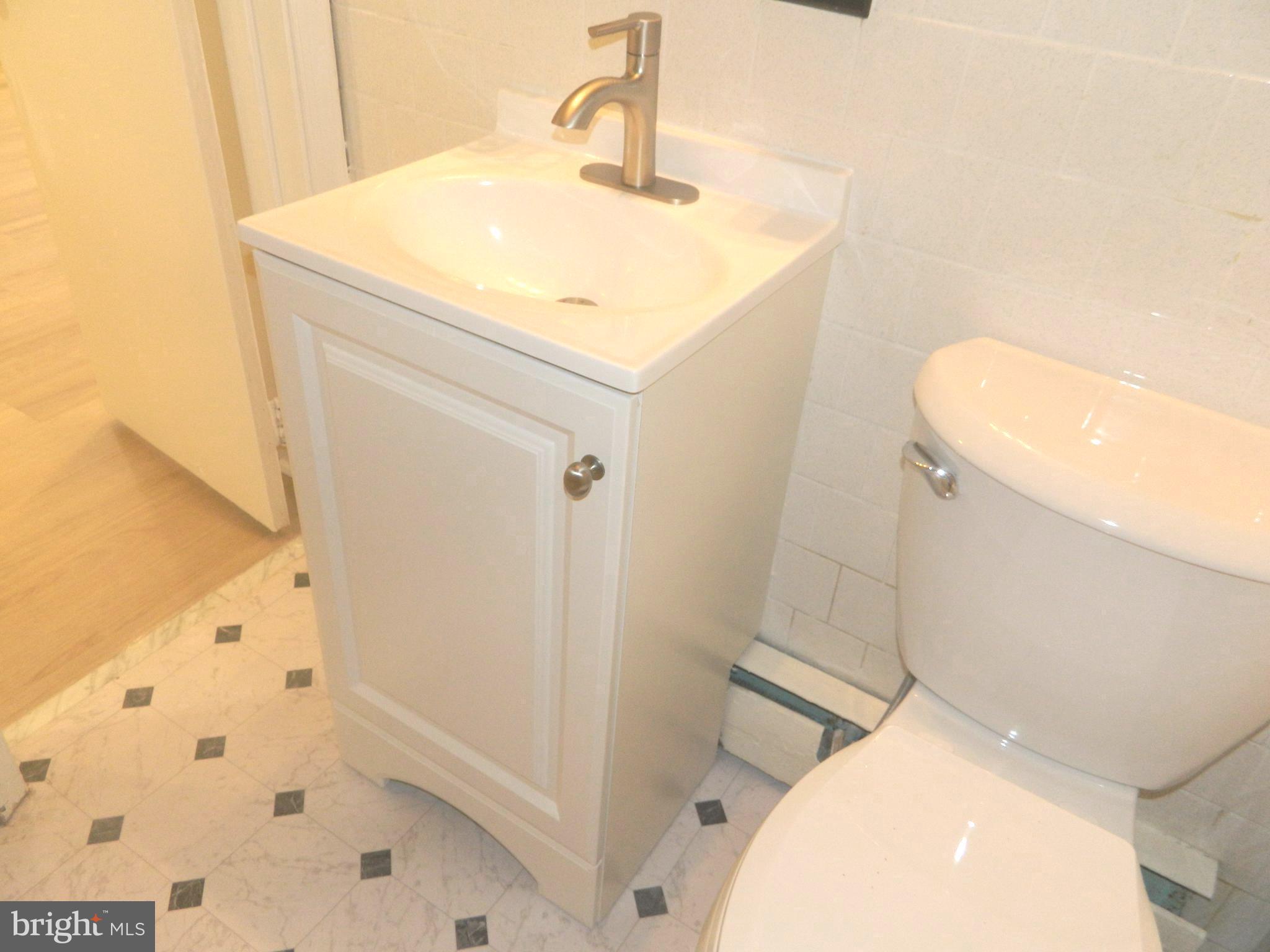 513 12th Street Northeast, Unit 9 Washington, DC 20002 - Photo 24 of 29 a bathroom with a sink a toilet and shower