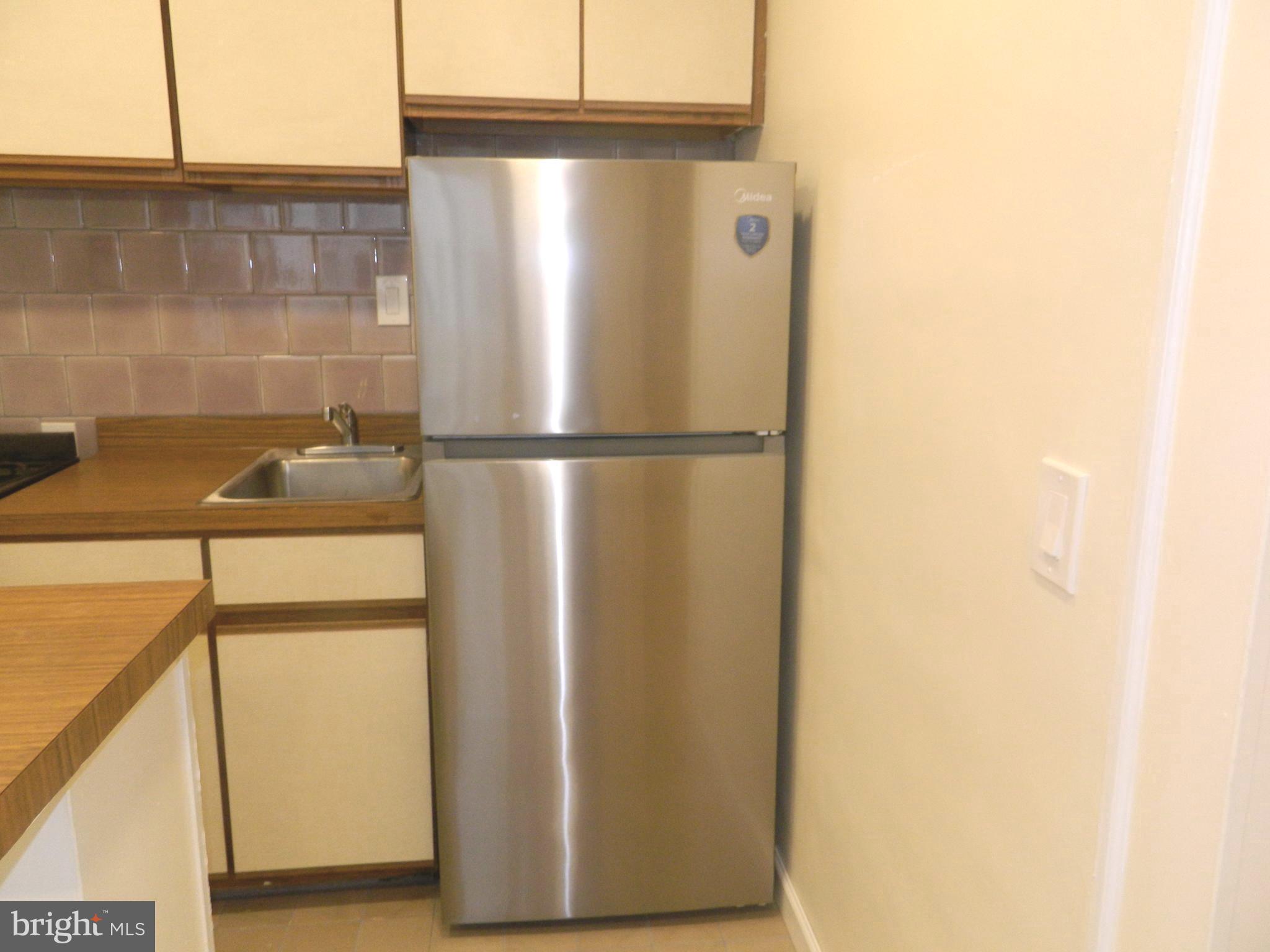 513 12th Street Northeast, Unit 9 Washington, DC 20002 - Photo 4 of 29 a white refrigerator freezer and a dishwasher