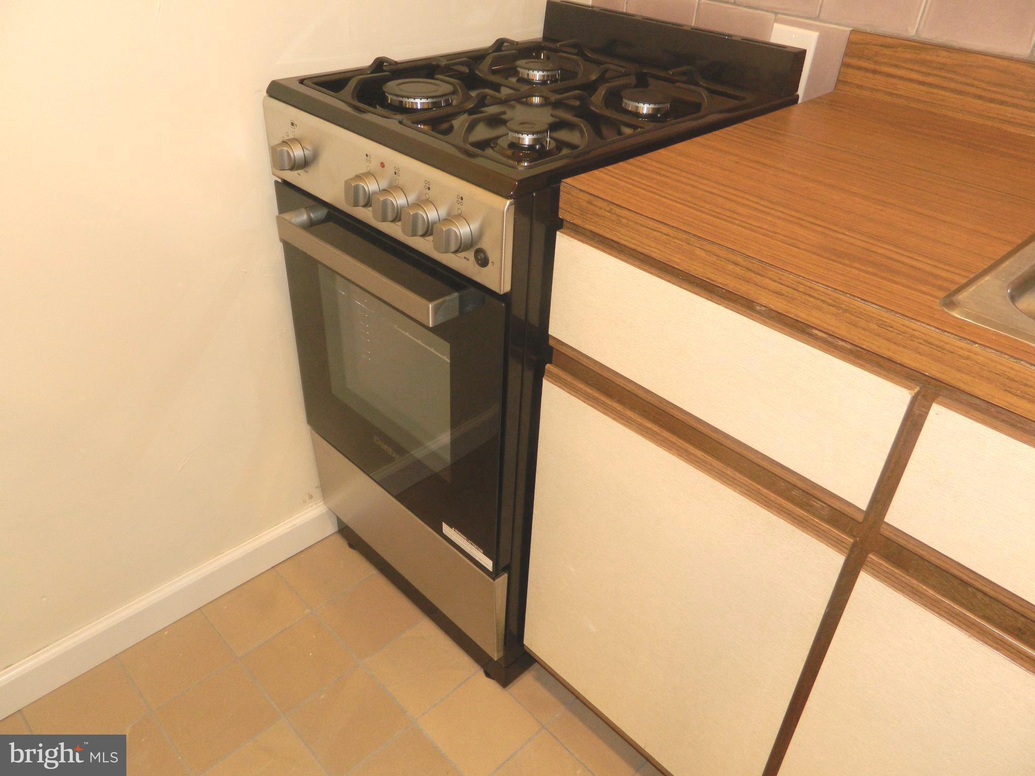 513 12th Street Northeast, Unit 9 Washington, DC 20002 - Photo 7 of 29 a kitchen with a stove and a window
