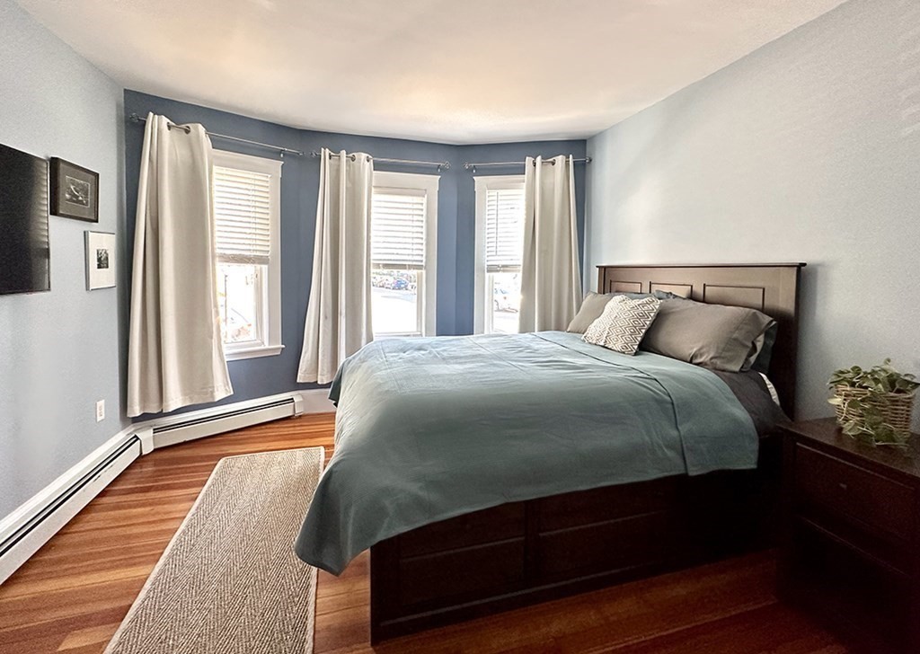 153 Rowe Street, Unit 1 Boston, MA 02131 - Photo 6 of 11 a bedroom with a bed and window