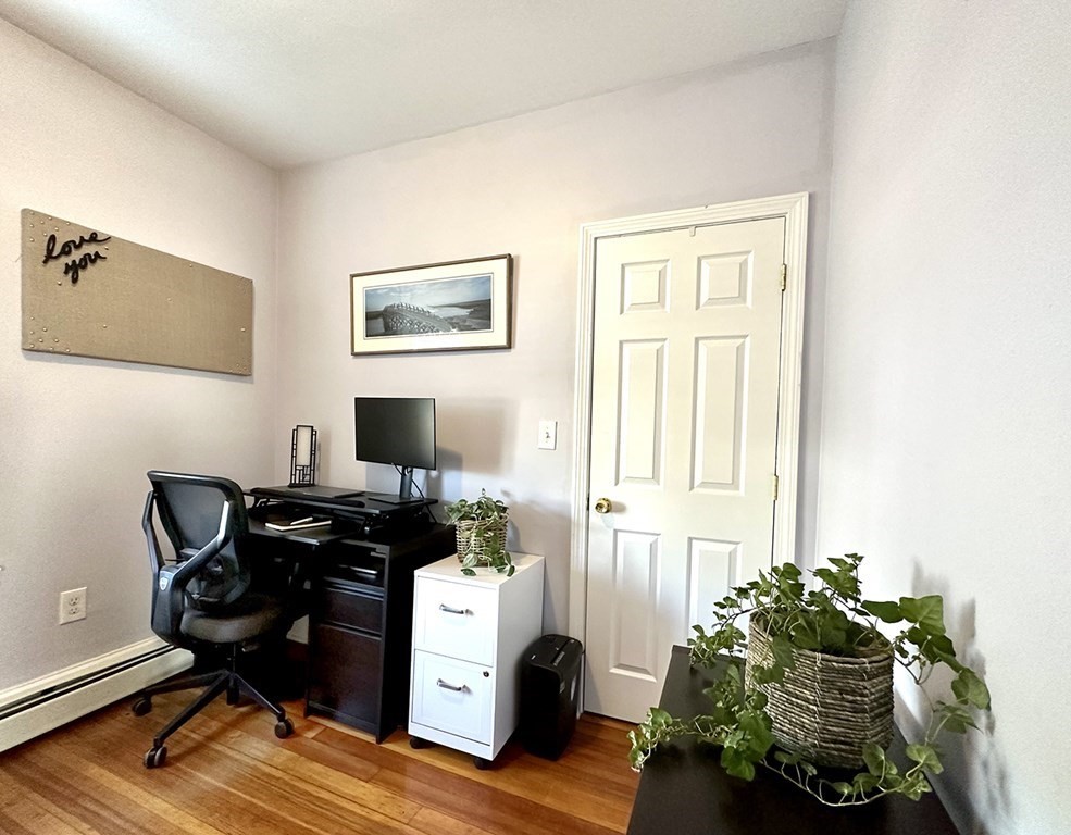 153 Rowe Street, Unit 1 Boston, MA 02131 - Photo 7 of 11 a livingroom with workspace and a window