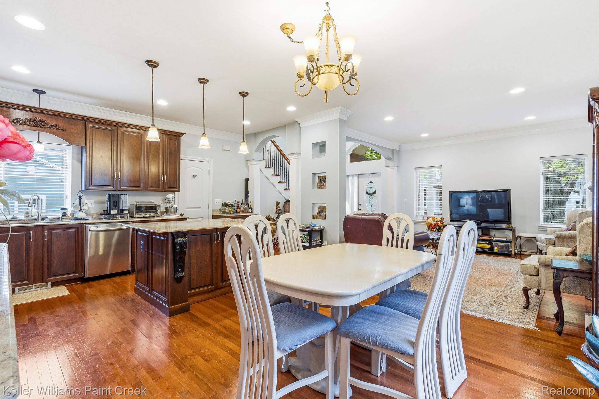 418 Oak Street Rochester, MI 48307 - Photo 16 of 38 Dining area with crown molding, hanging lights, dark wood finished floors, and healthy amount of natural light