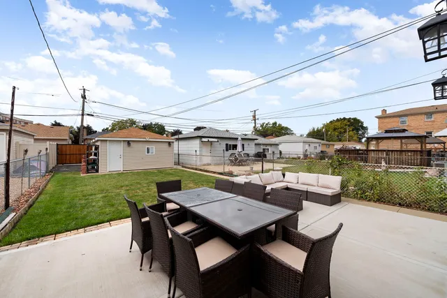 a view of a patio with couches table and chairs with wooden floor