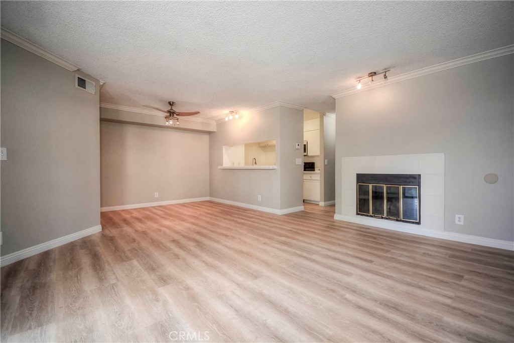 10655 Lemon Avenue, Unit 1001 Rancho Cucamonga, CA 91737 - Photo 12 of 22 a view of an empty room with a fireplace and a window