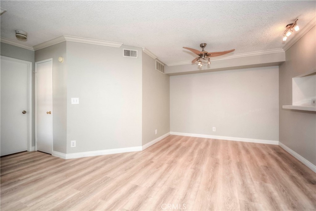 10655 Lemon Avenue, Unit 1001 Rancho Cucamonga, CA 91737 - Photo 13 of 22 an empty room with a ceiling fan and wooden floor