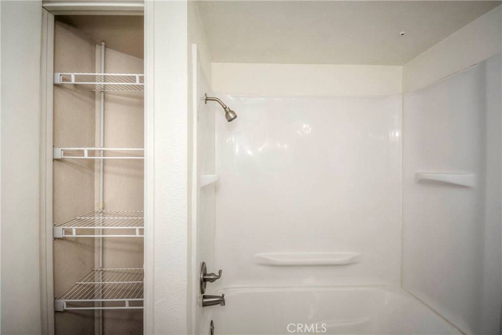 10655 Lemon Avenue, Unit 1001 Rancho Cucamonga, CA 91737 - Photo 20 of 22 a bathroom with a glass shower door