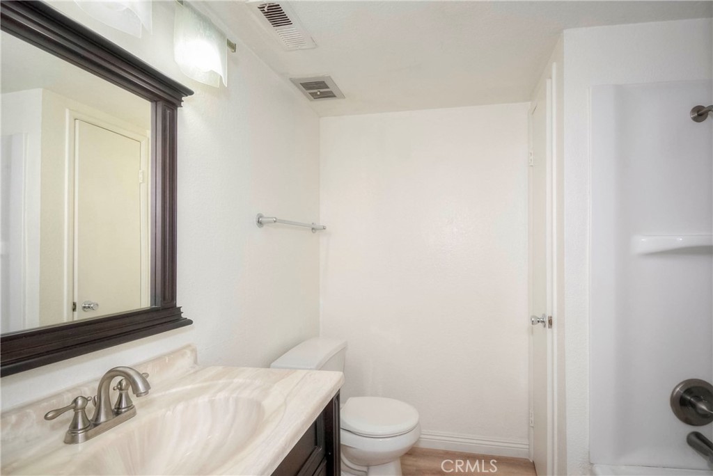 10655 Lemon Avenue, Unit 1001 Rancho Cucamonga, CA 91737 - Photo 21 of 22 a bathroom with a granite countertop sink toilet and shower
