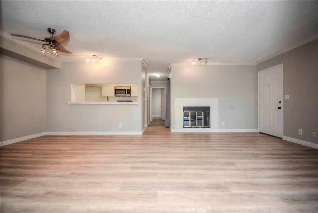 10655 Lemon Avenue, Unit 1001 Rancho Cucamonga, CA 91737 - Photo 8 of 22 a view of an empty room with window and wooden floor