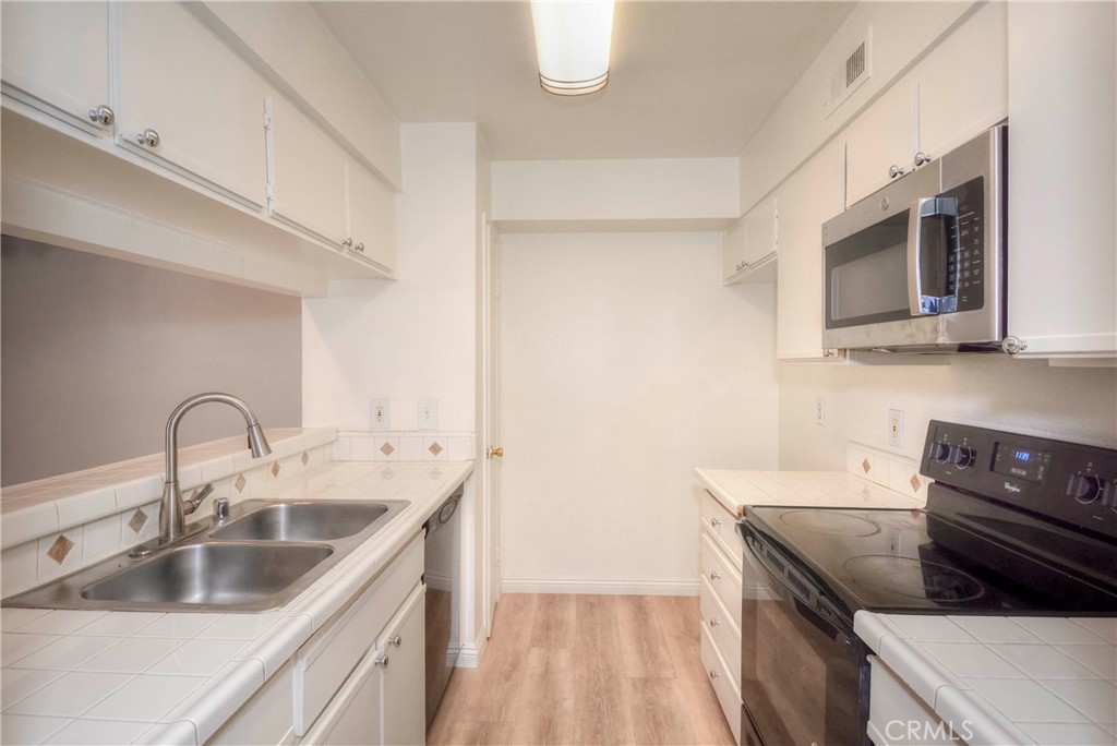 10655 Lemon Avenue, Unit 1001 Rancho Cucamonga, CA 91737 - Photo 9 of 22 a kitchen with a sink and a stove top oven
