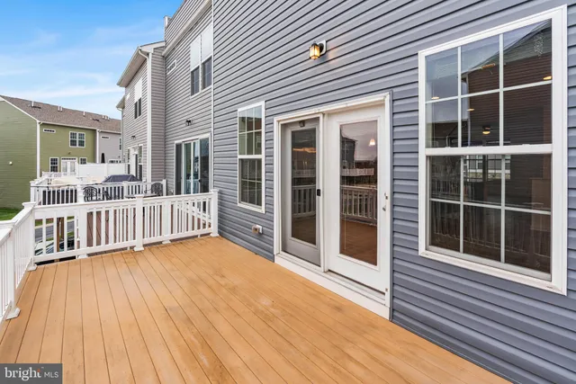 a view of a house with a wooden deck