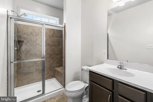 a bathroom with a sink mirror and toilet
