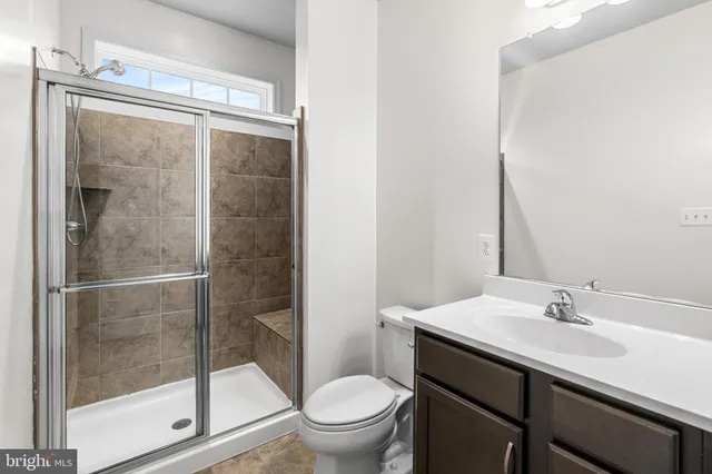 a bathroom with a sink mirror and toilet