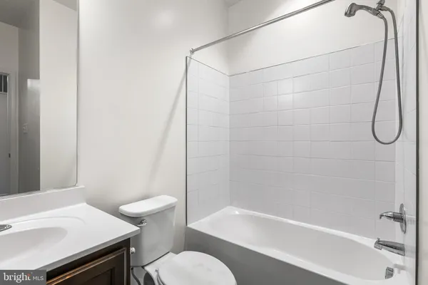 a bathroom with a sink a toilet and a bathtub