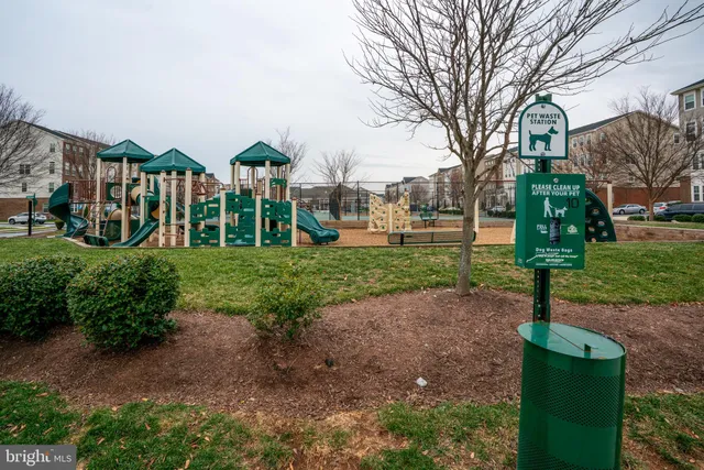 a front view of a house with garden and trees