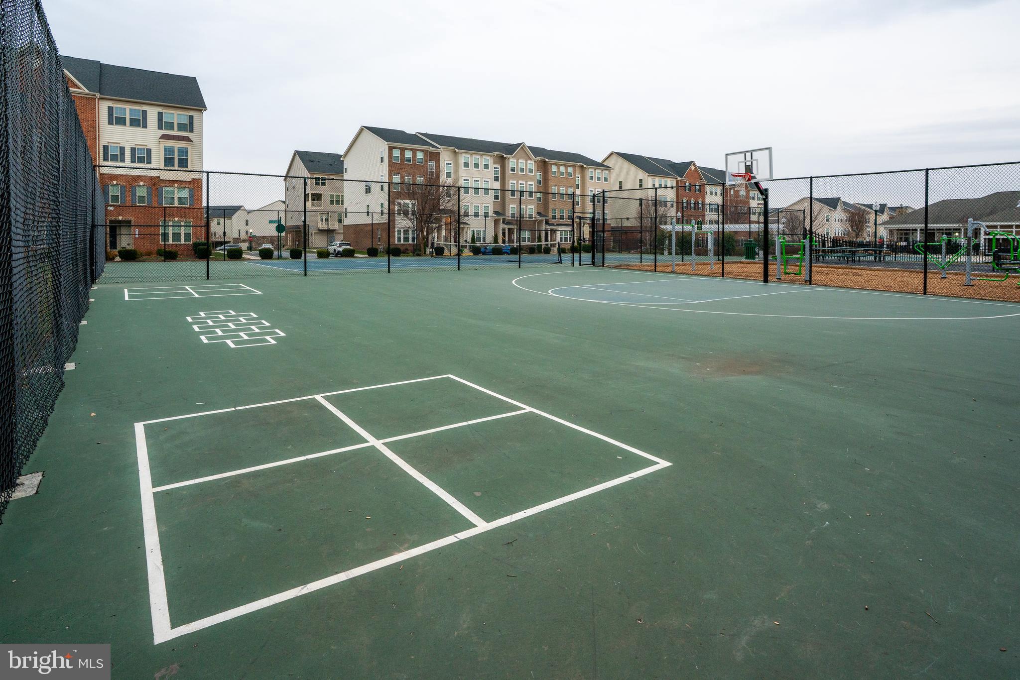 6202 Davinci Street Frederick, MD 21703 - Photo 34 of 36 a view of a tennis ground with large trees