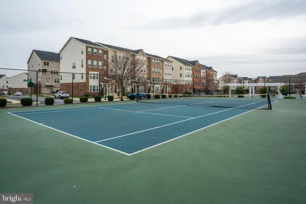 a view of a big building with a big yard and large trees