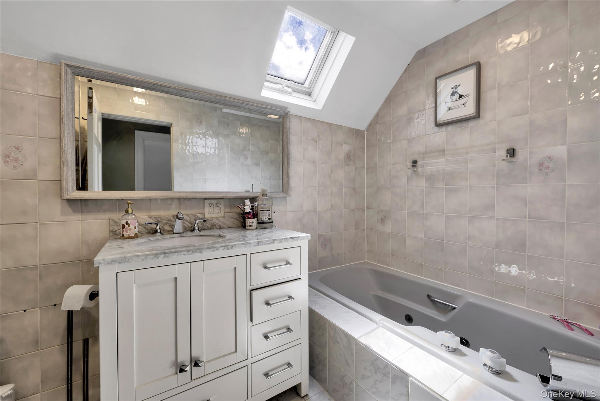5 Argyle Road Merrick, NY 11566 - Photo 12 of 31 a bathroom with a granite countertop sink a mirror a bathtub and shower