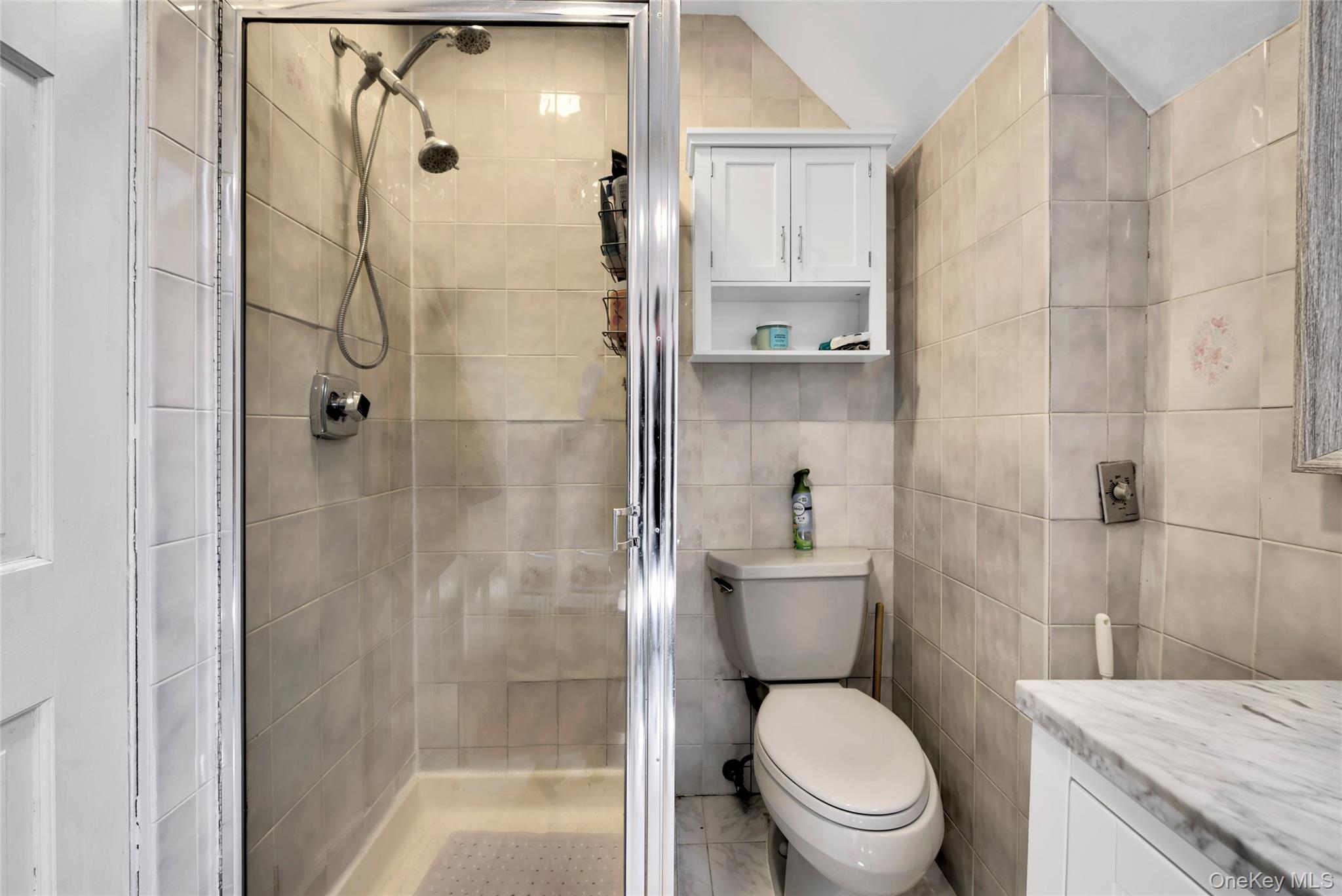 5 Argyle Road Merrick, NY 11566 - Photo 13 of 31 a bathroom with a granite countertop toilet a sink and shower