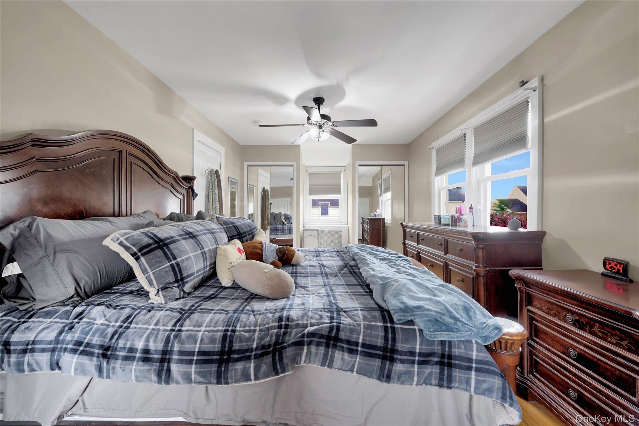 5 Argyle Road Merrick, NY 11566 - Photo 18 of 31 a bedroom with furniture and a chandelier