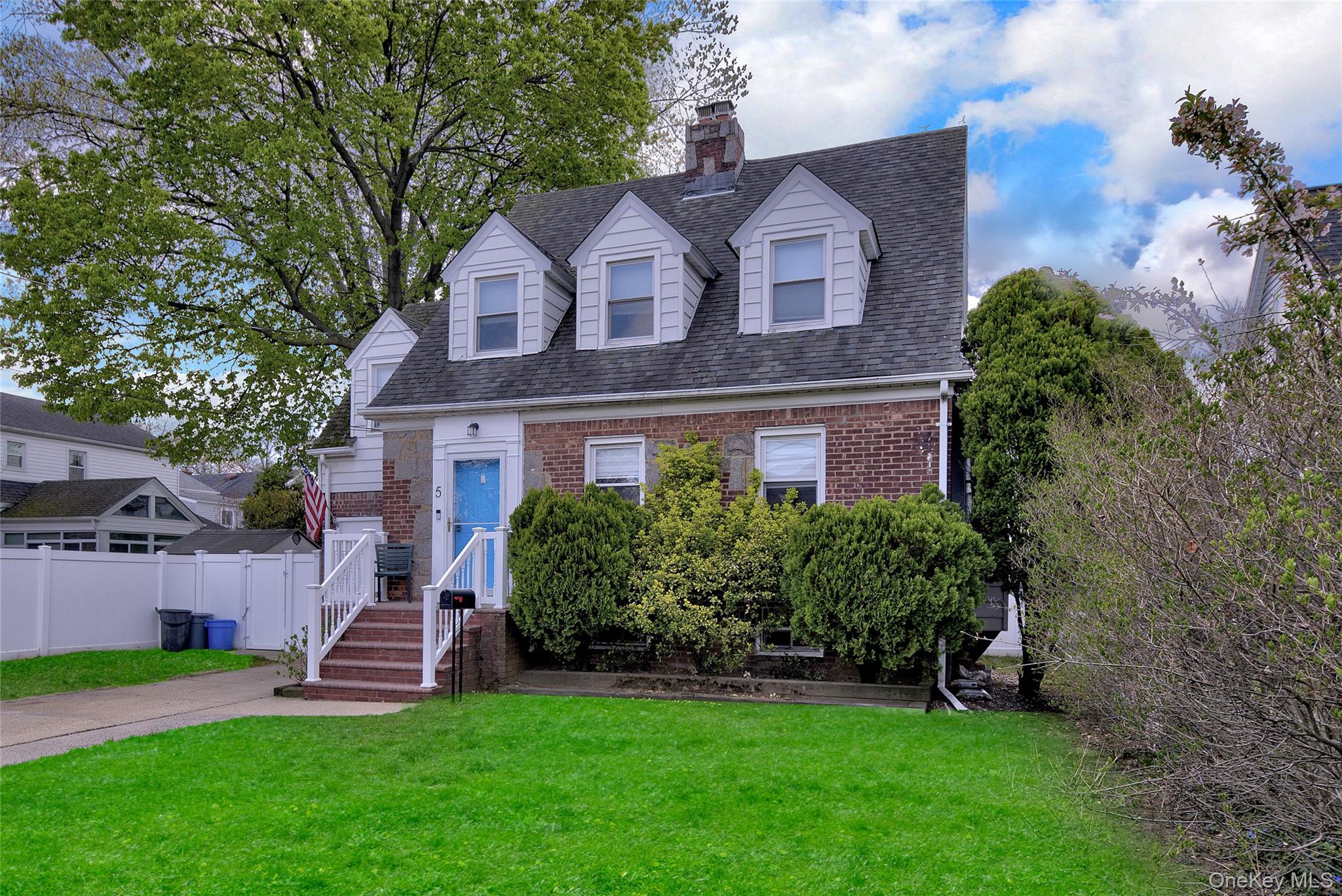5 Argyle Road Merrick, NY 11566 - Photo 2 of 31 a front view of a house with a yard and green space
