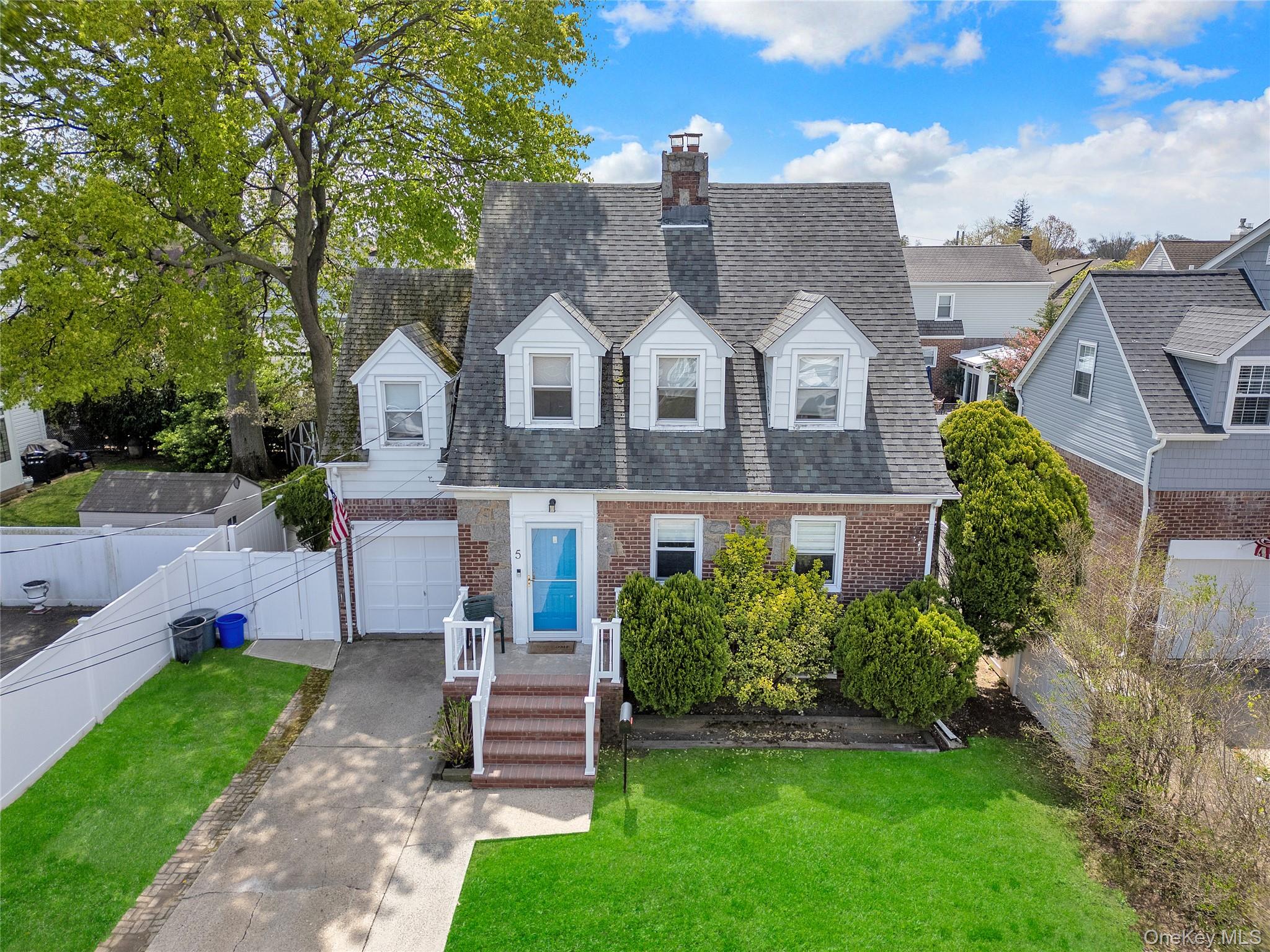 5 Argyle Road Merrick, NY 11566 - Photo 28 of 31 a front view of a house with a garden