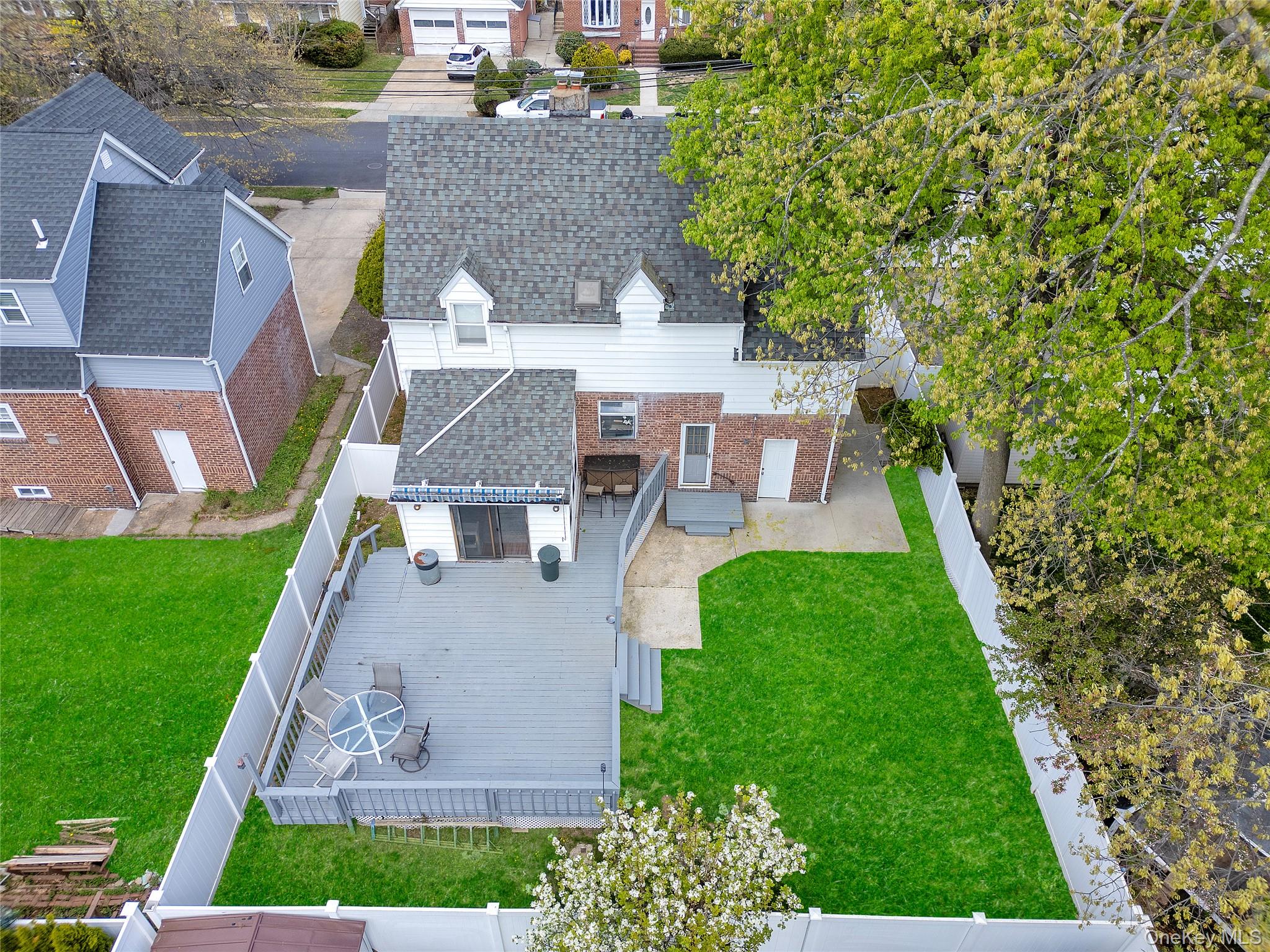 5 Argyle Road Merrick, NY 11566 - Photo 31 of 31 a view of a patio with table and chairs potted plants and large tree