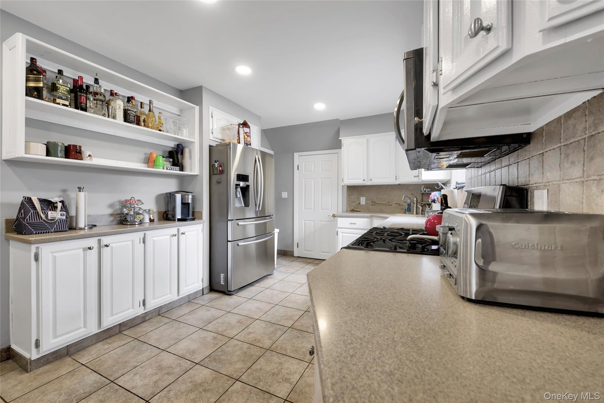 5 Argyle Road Merrick, NY 11566 - Photo 8 of 31 a kitchen with refrigerator and cabinets